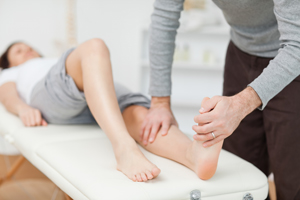 This is a picture of a physical therapist stretching a patient foot.